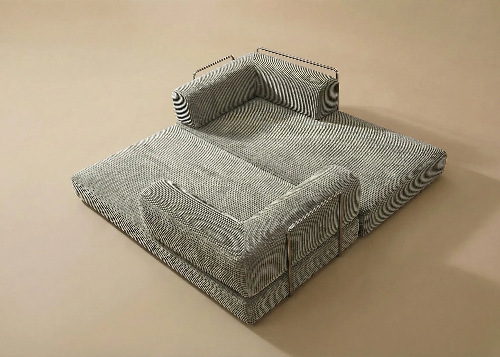Sofá cama Taburiente sin estructura con diseño moderno y tapizado gris de textura suave y detalles metálicos.