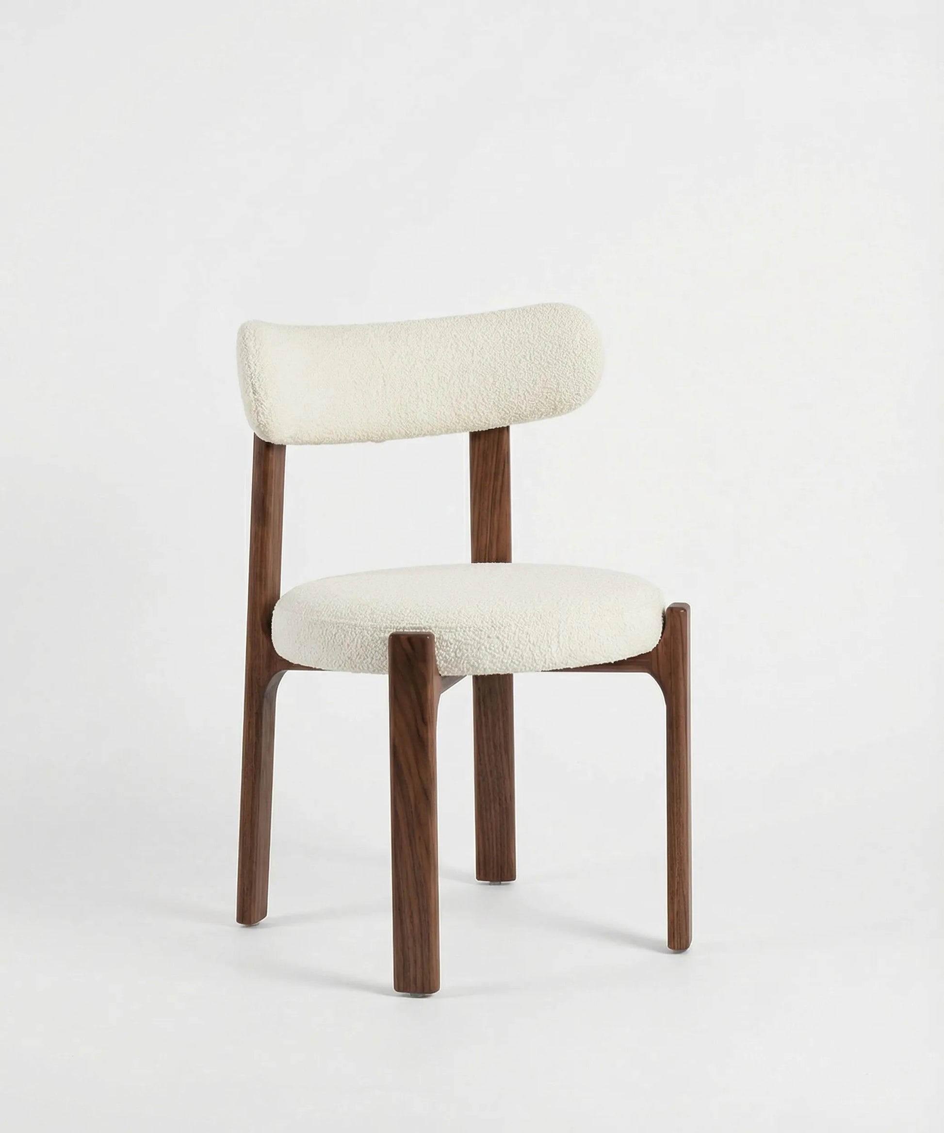 Silla Malpica con estructura de madera de fresno y tapizado blanco, diseño contemporáneo de líneas suaves y acogedoras.