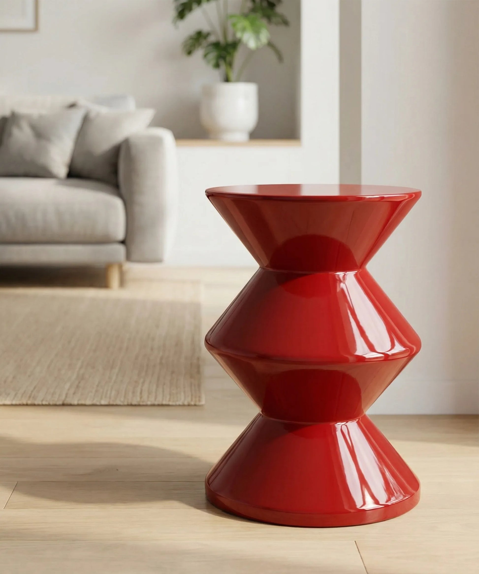 Mesa auxiliar Amanay en fibra de vidrio con silueta escultural y acabado rojo intenso para ambientes modernos.