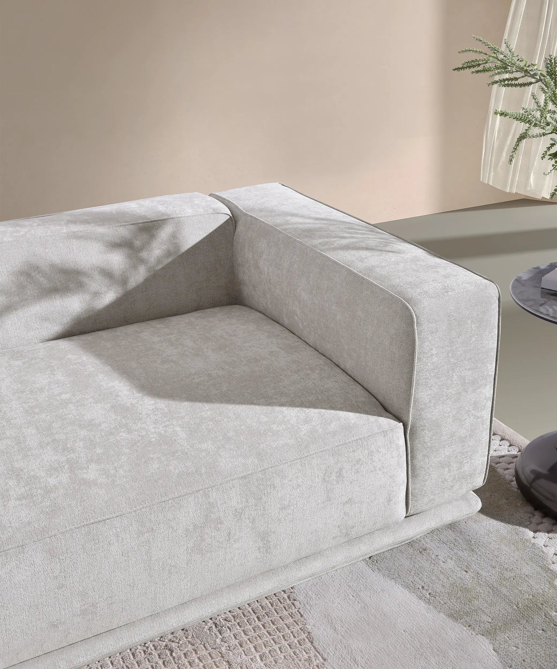 Detalle del brazo y asiento del sofá Palmero en tela gris claro con diseño moderno y estructura robusta.