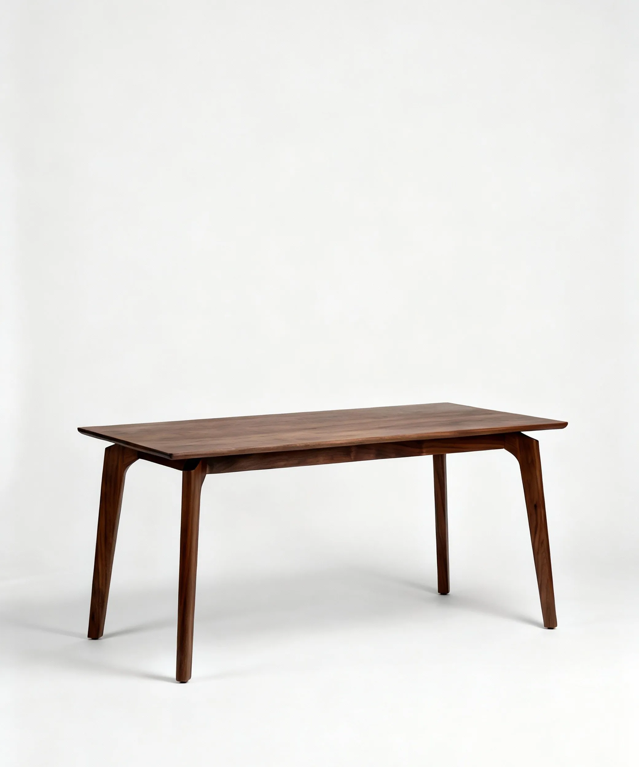 Mesa Tirajana de diseño minimalista en madera de fresno con acabado en nogal oscuro, ideal para comedor moderno.